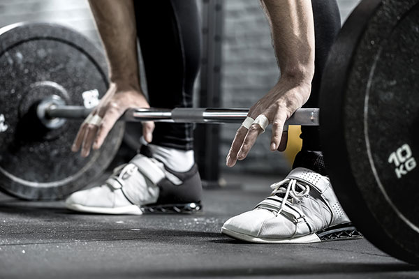 Person getting ready to lift weights